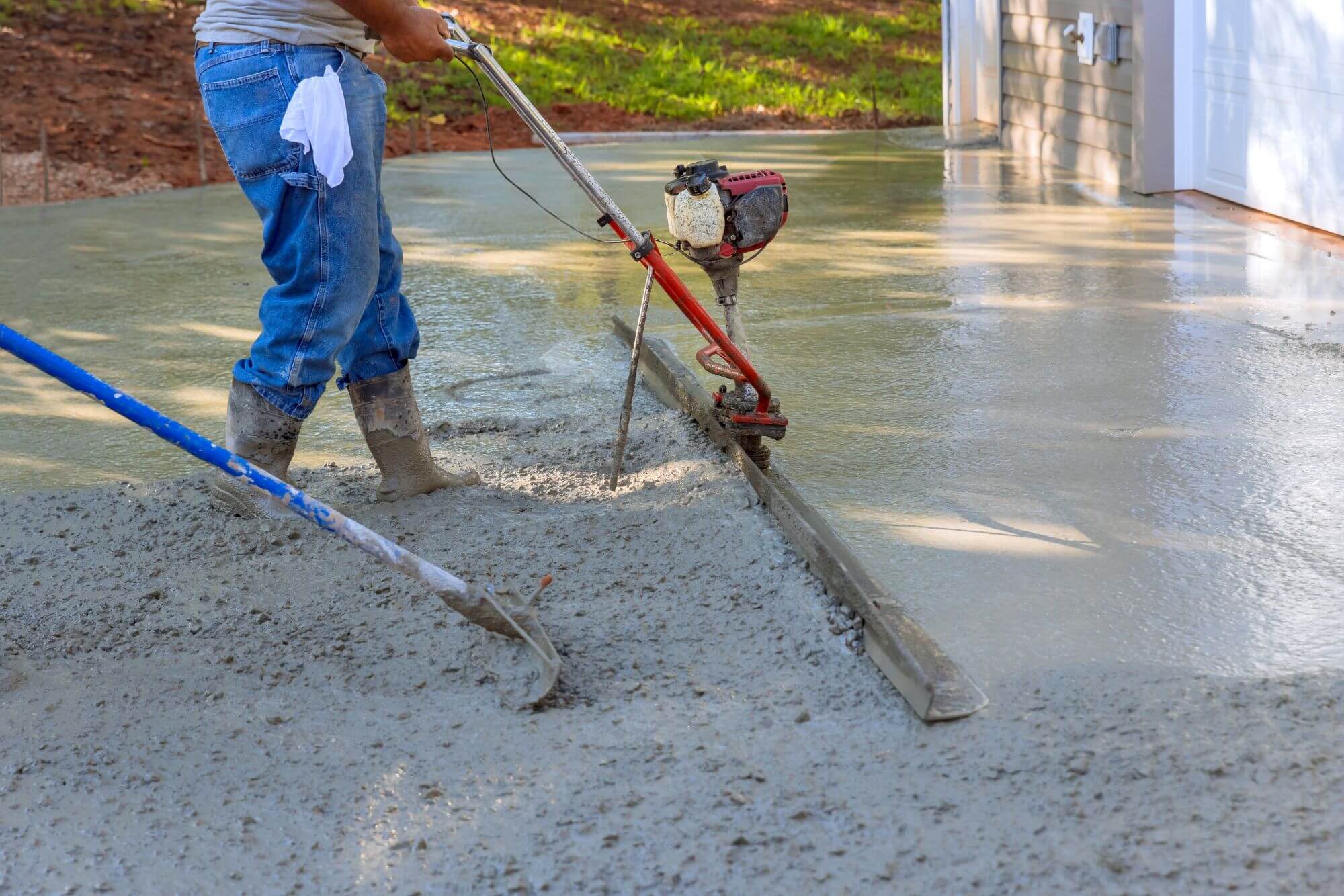 Concrete contractor in Denver installing a new residential driveway with clean, smooth finish